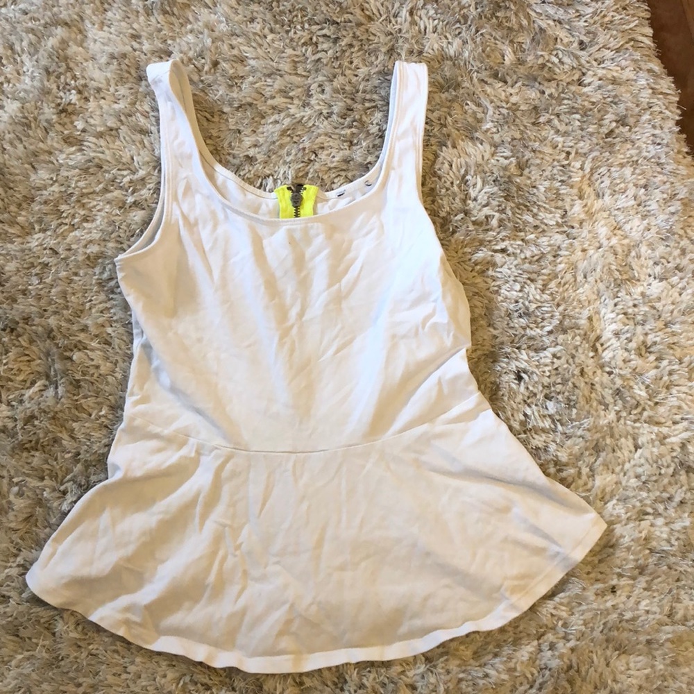 White peplum tank with neon yellow zipper on back